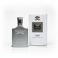 Creed Himalaya perfume bottle and packaging on a textured surface with flowers in the background.