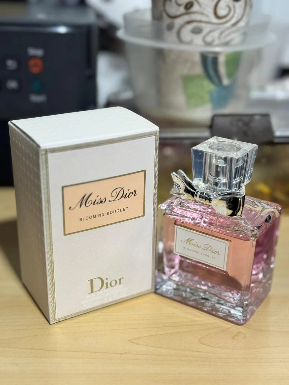 Miss Dior perfume bottle and packaging on a wooden surface
