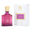 Pink Creed Carmina perfume bottle with white box on a white background